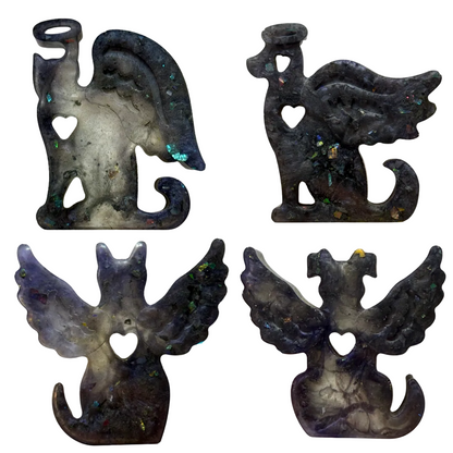 Dog, cat angel figurines with wings on a beige background.
