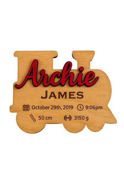Wooden train-shaped plaque with engraved baby name and birth statistics, date, time of birth, length, weight
