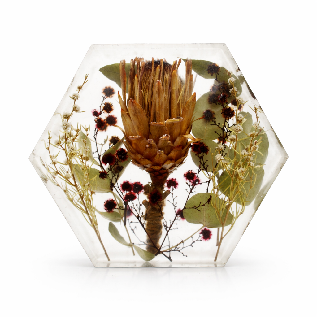 hexagon resin keepsake with wedding flowers inside.