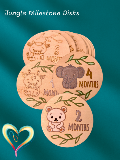 Wooden milestone disks with animal illustrations and months printed on them against a teal background.