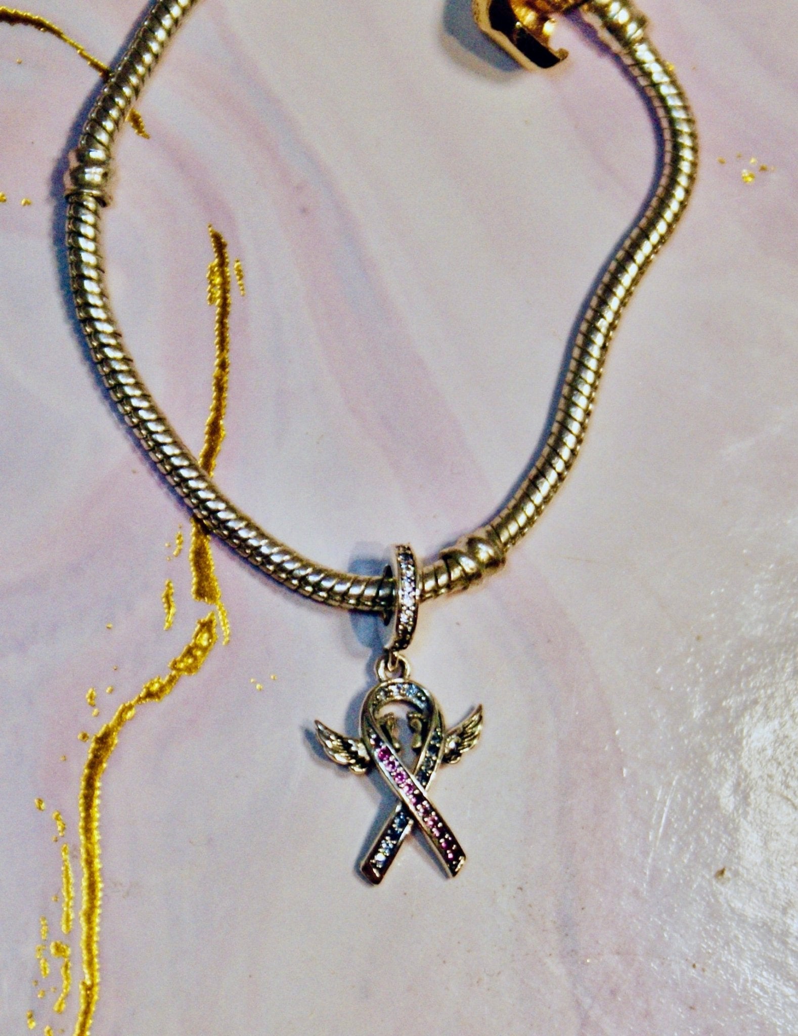 Pregnancy and infant loss awareness ribbon charm in sterling silver with pink and blue stones